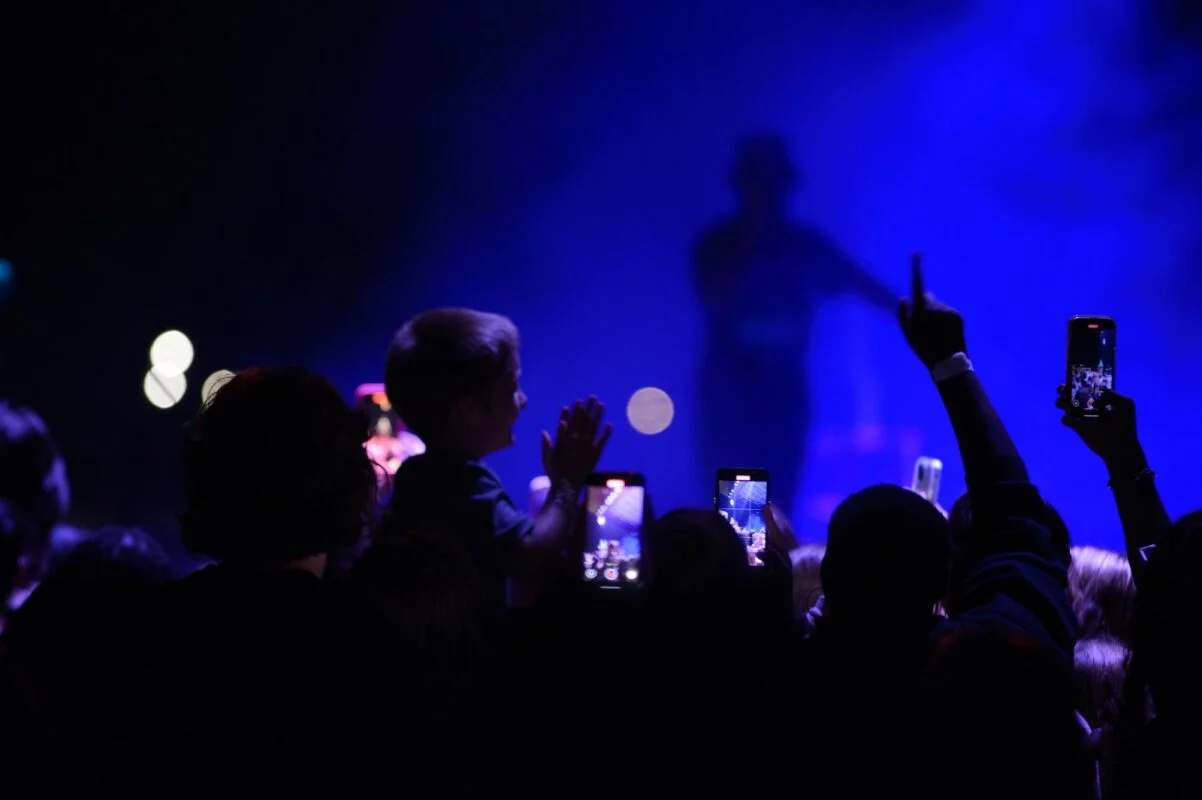 The crowd worshipping under blue stage lights at last year's concert