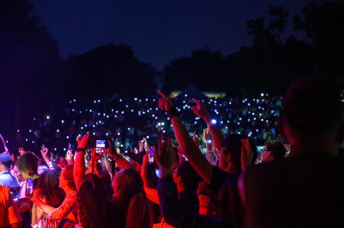The amphitheatre crowd lit by phone lights at night during last year's concert